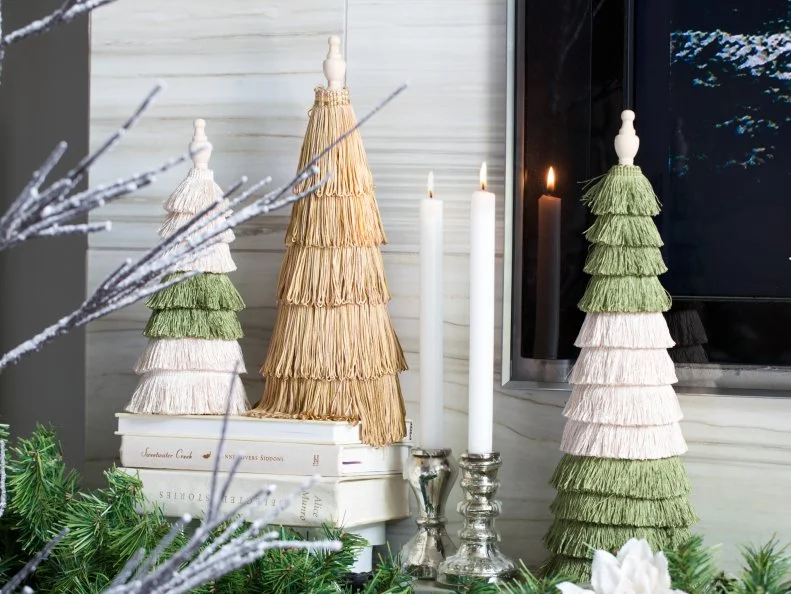 For this mantel design, sheen was added via a trio of crafting cones covered in fringe trim, metallics are present in the pewter candle sticks.