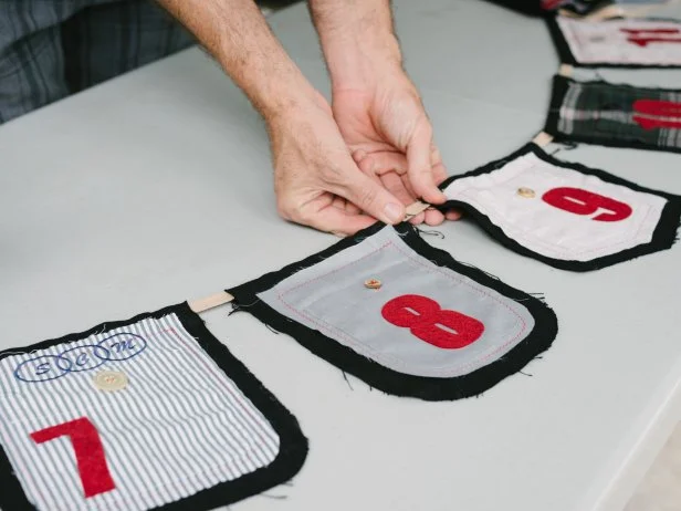 Fish the 3/4-inch canvas banding through flaps in the back of each pennant. Once all pennants are in place, ensure even spacing by adjusting individually along banding.