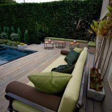 Modern Deck With Pool and Green Cushioned Seating 