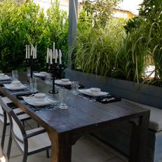 Outdoor Dining Area With Large Rustic Table And Banquette