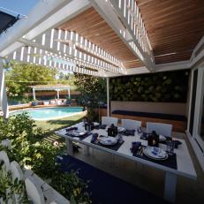 Outdoor Dining Room With White Table and Pergola