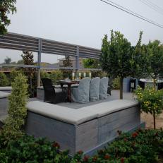 Outdoor Dining Area With Gray Slipcovered Chairs & Bench Seating