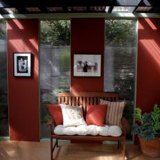 Red Outdoor Sitting Room With Wood Bench 