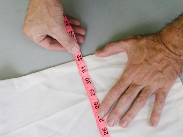 White Fabric Measured With Pink Measuring Tape