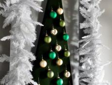 DIY Christmas tree from fiberboard and fabric with ornaments.