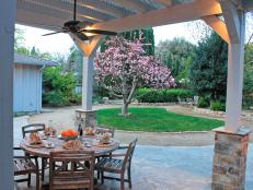 Landscape designer Michael Glassman creates an outdoor oasis with beautiful plantings, a flagstone patio and al fresco dining.