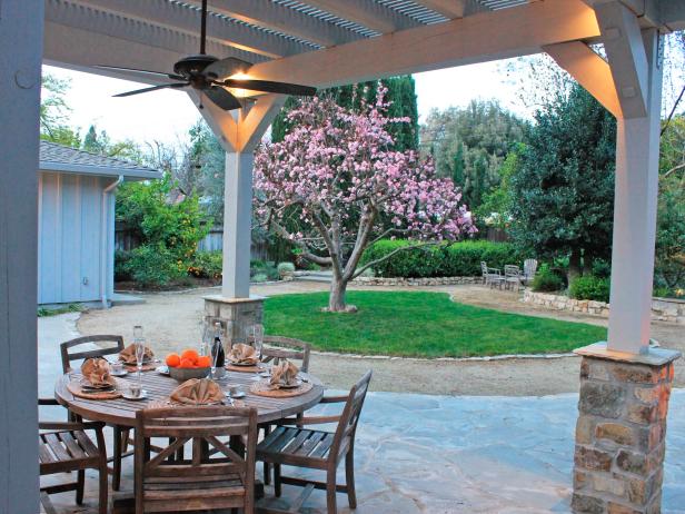 Stone Patio With Wood Table & Chairs, White Pergola With Stone Columns