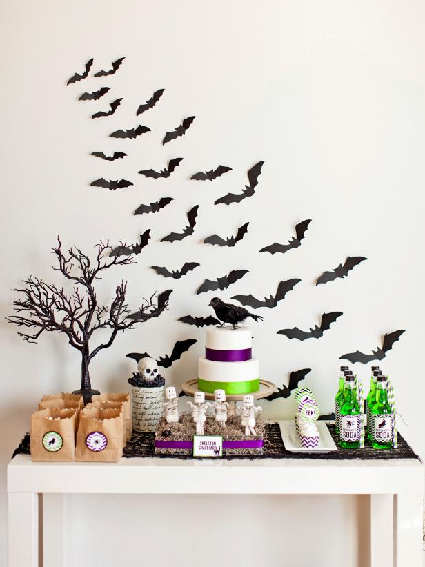 Paper bats climbing the wall add a fabulous spook factor to this Halloween dessert table.