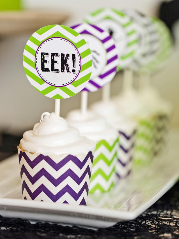 Cupcakes with purple or green chevron stripe baking cups and matching toppers are the perfect dessert for a festive and fun Halloween party.