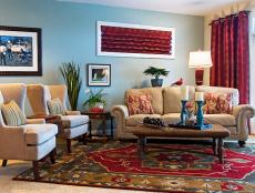 Designer Sandy Kozar creates a relaxing family room full of favorite artwork and travel souvenirs where a retired couple can each entertain their friends.