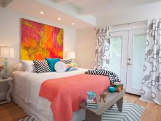 Cheery Master Bedroom with Chevron Rug and Bright Painting Above Bed