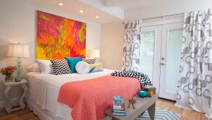Cheery Master Bedroom with Chevron Rug and Bright Painting Above Bed