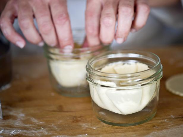 Carefully place dough into mini glass Mason jar. Use your fingers to press dough against jar's walls so that it fills up the entire jar.