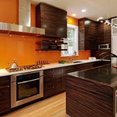 Contemporary Orange Kitchen With Zebrawood Cabinets and Island