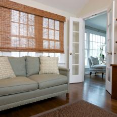 Transitional Area with Seafoam Sofa and Bamboo Curtains