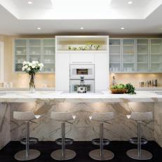 Contemporary White Kitchen With a Waterfall-Style Calacatta Marble Island 