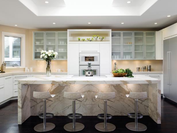 Contemporary White Kitchen With a Waterfall-Style Calacatta Marble Island 