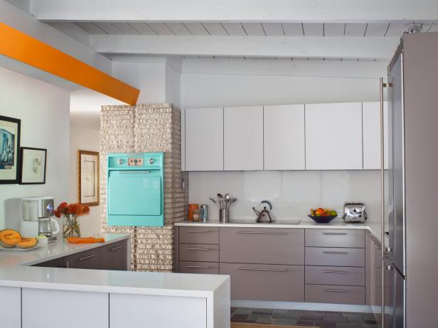 A bold retro oven is featured alongside white and gray cabinets in this midcentury kitchen makeover by Savannah-based designer Celestino Piralla.