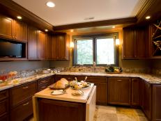 Kitchen With Wooden Cabinets and TV