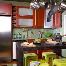 Small Green Kitchen With Wood Cabinets and Dining Area