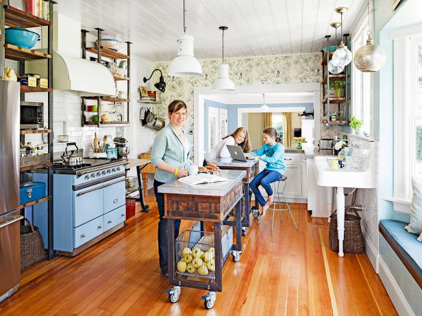 The two zinc-top islands add about 11 square feet of counter space. The metal frames match the open shelves, and the zinc tops will develop a pretty patina over time. Casters allow them to scoot around for flexibility and easy floor cleaning.