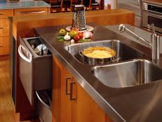 Both traditional and contemporary, stainless steel works for most kitchen styles. Since it's a metal and nonporous, it doesn't have to be sealed and is naturally antibacterial. Another bonus, stainless steel is easy to clean with soap and water following the grain of the metal. Just be sure to dry with a clean cloth after to reduce water spots. For tough stains or scratches, stainless steel cleaner is available. Design by Barb Ince