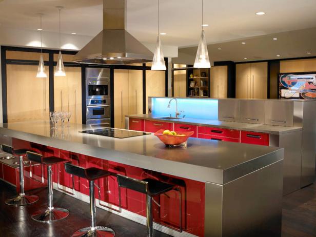 Steve Johnson and Bradford Fox designed this kitchen's two colossal islands to anchor a 1500-square-foot open space. One island boasts a CaesarStone quartz countertop, the other stainless steel to complement the red lacquer and maple Poggenpohl cabinetry. Cool touch: The translucent glass backsplash changes color on demand. Photo courtesy of Poggenpohl Atelier Inc.