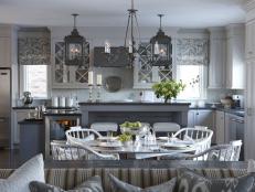 White Eat-in Kitchen With Gray Hues, Lantern Lighting and Tall Island