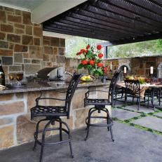 Outdoor Kitchen and Dining Area With Barstools