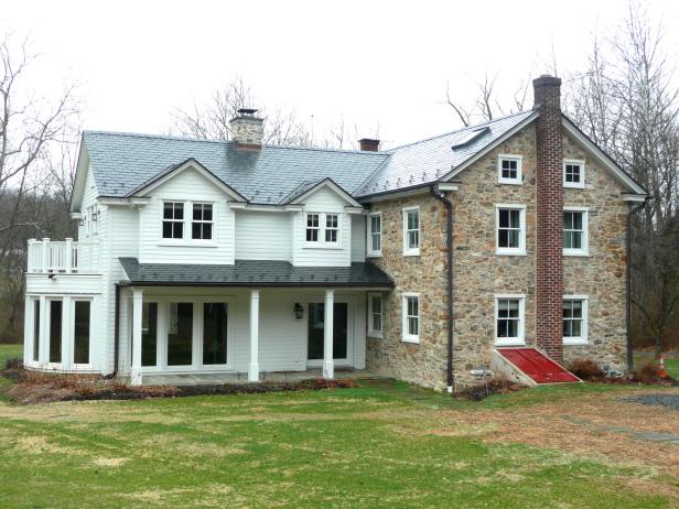 Traditional Farmhouse Exterior With White Siding and Stone