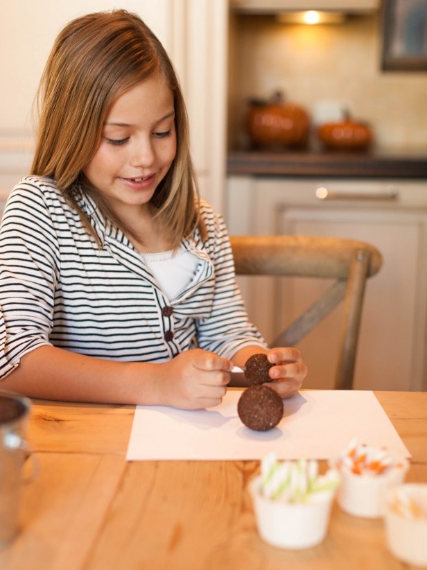 Girl making foam and straw turkey