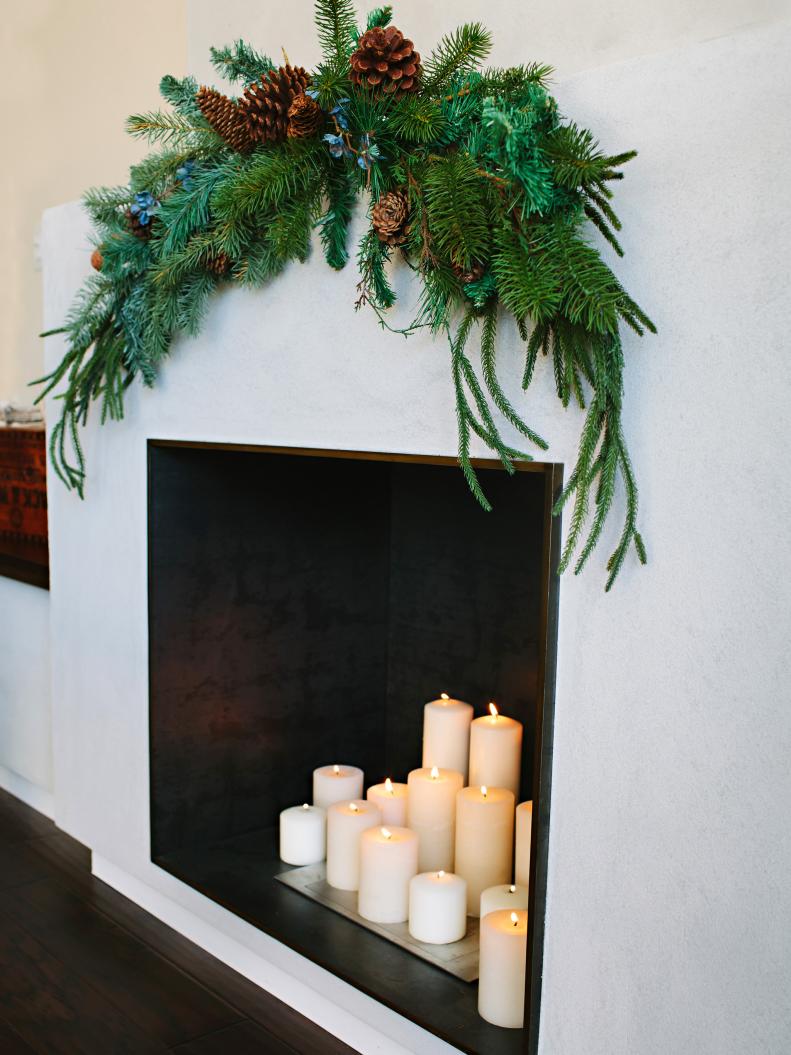 White candles in fireplace