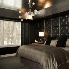 Striking Black Bedroom With Tufted Leather Headboard