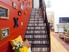 Red Stairway With Framed Photos and Black & White Patterned Steps