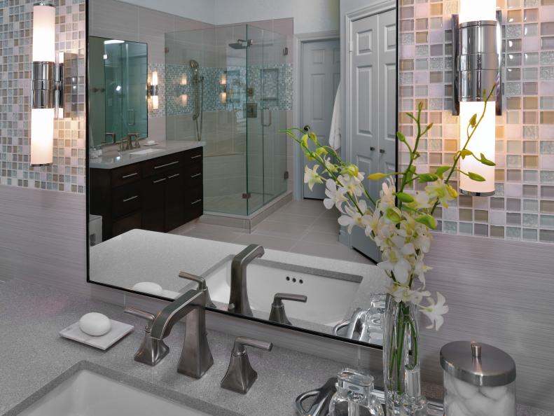 Bathroom Mirror Reflecting Glass-Enclosed Shower, Dark Vanity, Closet