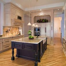 Old World Kitchen With Glazed Floor-to-Ceiling Cabinets and Granite Backsplash