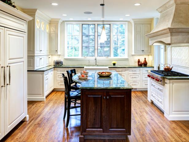 Traditional White Kitchen With Walnut Island and Marble Countertops