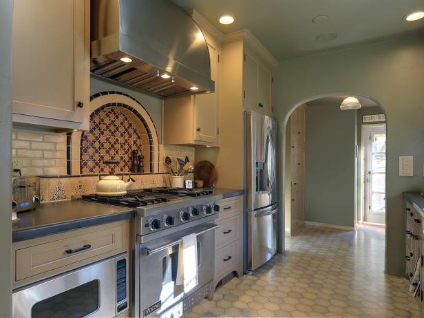 Mediterranean Kitchen With Mosaic Backsplash and Arched Door