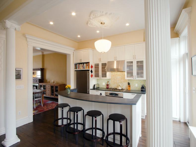 Yellow Kitchen with White Cabinets and Columns