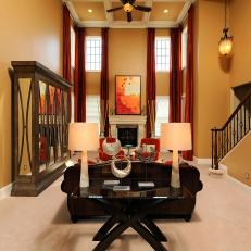 Two-Story Transitional Living Room With Orange Accents
