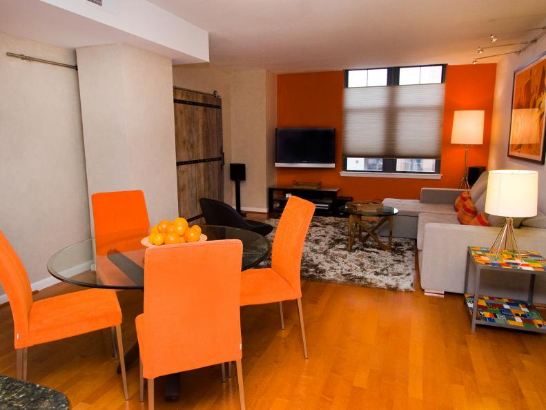 Orange Dining Chairs and Accent Wall in Neutral Open-Plan Room