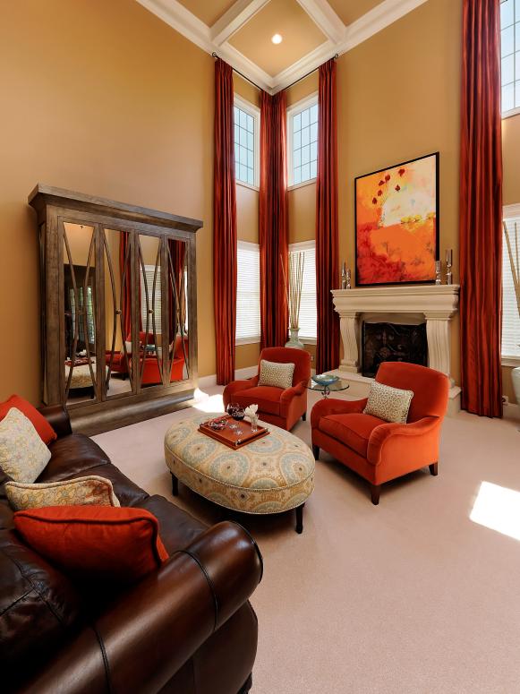 High Ceiling in Living Room with Orange Chairs and Brown Leather Sofa