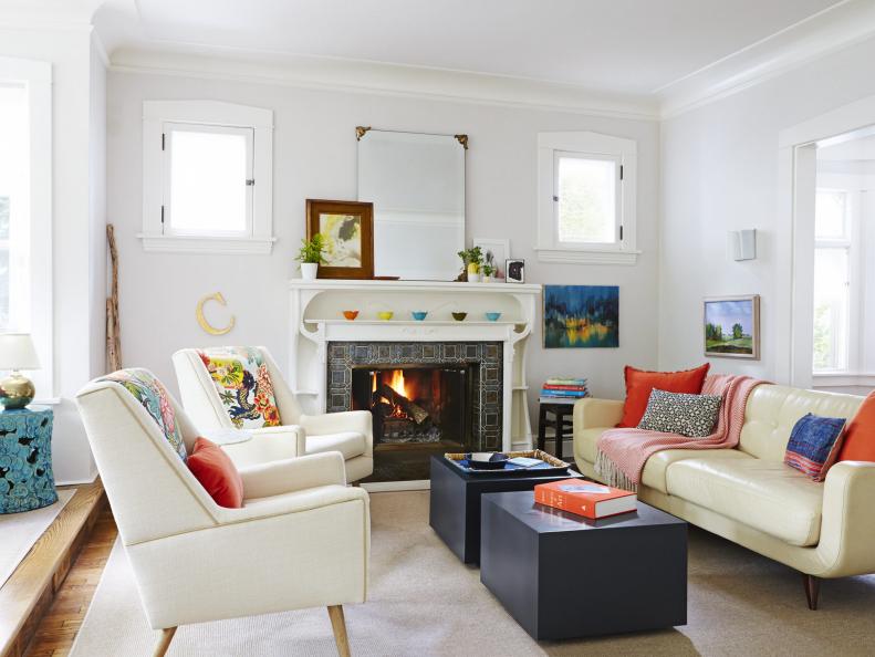 White, eclectic living room with colorful accents. 