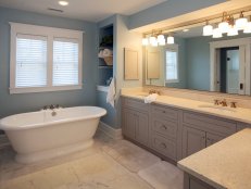 Double Vanity Bathroom With Freestanding Tub and Built-In Shelving