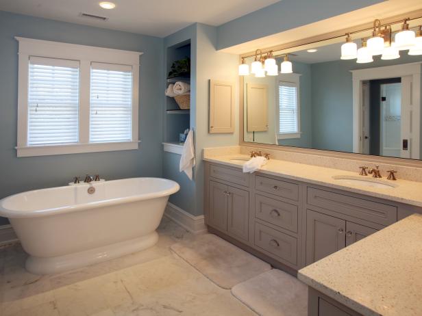 Modern bathroom with freestanding bathtub, modern taps and blue