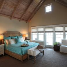 Vaulted Ceiling Expands Neutral Cottage Bedroom