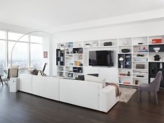 White Living Space With Dark Hardwood Floors and Entertainment Storage