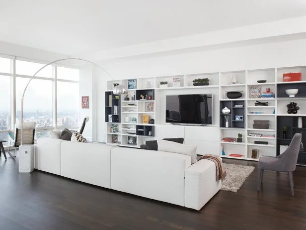 White Living Space With Dark Hardwood Floors and Entertainment Storage