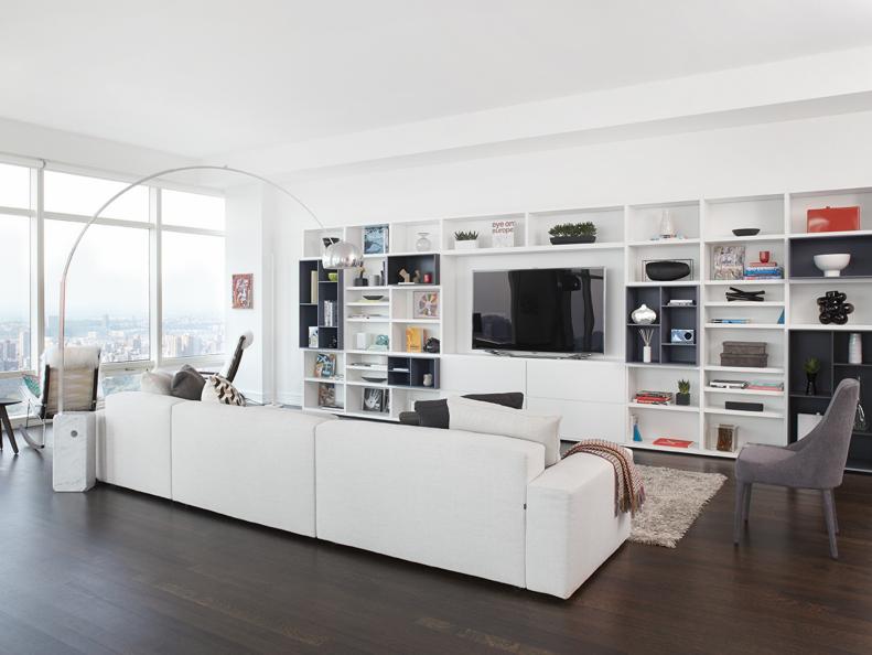 White Living Space With Dark Hardwood Floors and Entertainment Storage