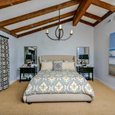 Tropical Master Bedroom With Incline Ceiling and Exposed Beams 